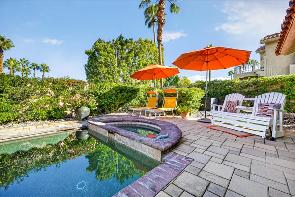 a view of swimming pool with outdoor seating