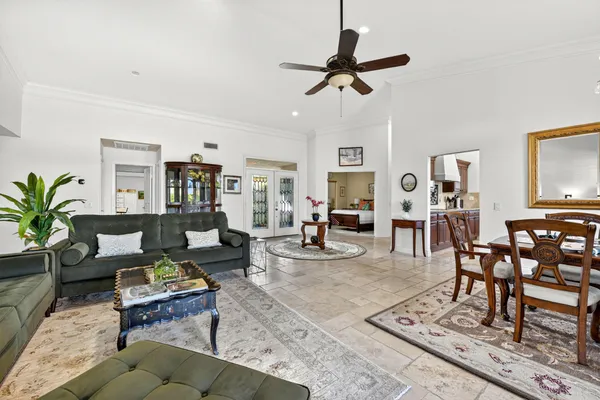 a living room with furniture potted plant and a flat screen tv