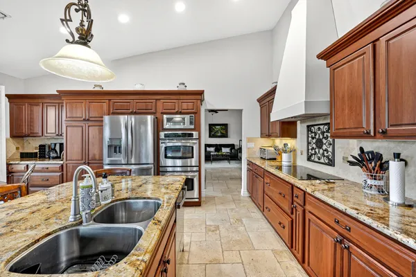 a kitchen with a stove a sink and a refrigerator