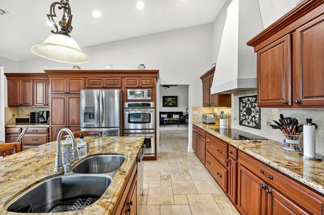 a kitchen with a stove a sink and a refrigerator