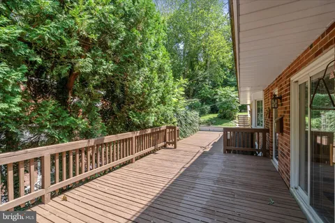 a view of a patio with table and chairs and wooden floor
