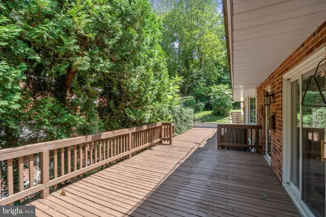 a view of a patio with table and chairs and wooden floor