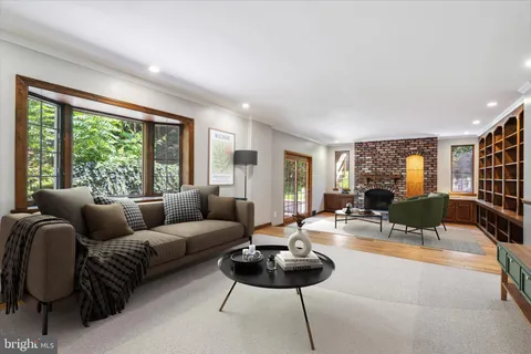 a view of fireplace and windows in an empty room