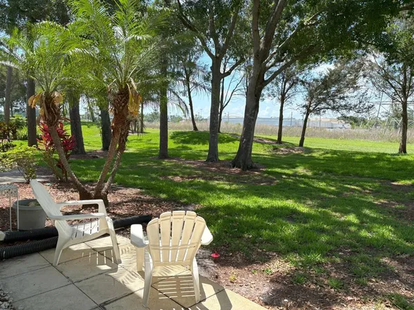 a view of a chairs and table in backyard