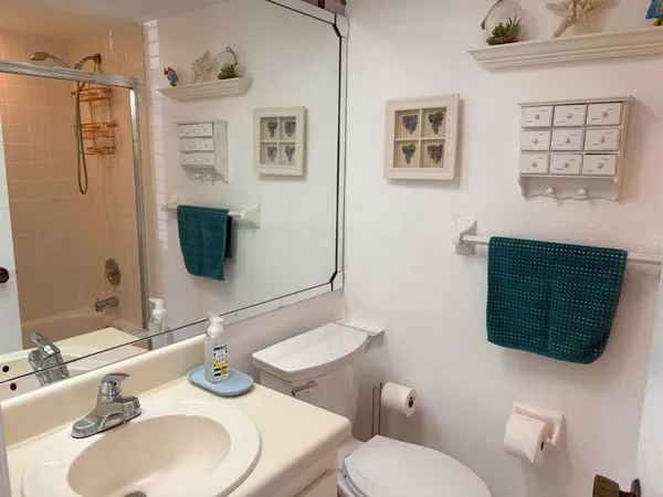 a bathroom with a sink toilet and mirror
