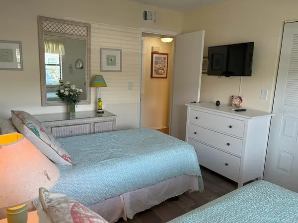 a bedroom with a large bed and a flat screen tv