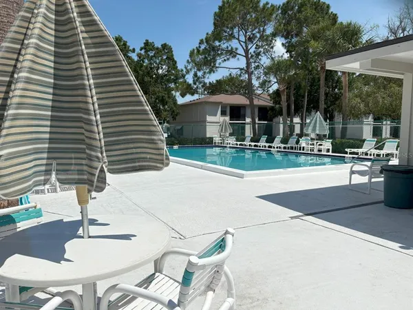 a backyard of a house with table and chairs