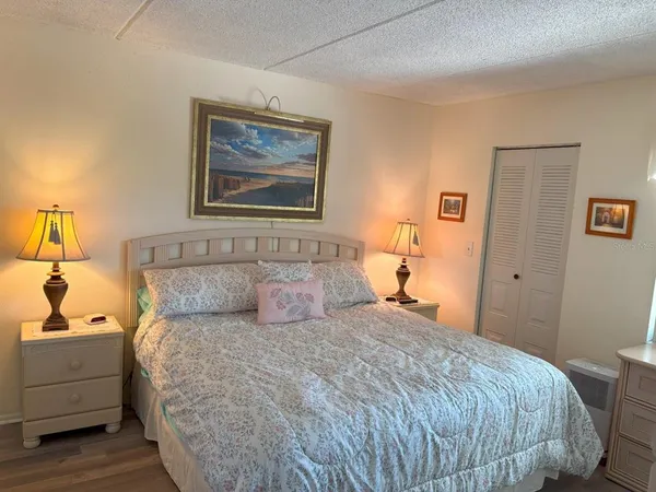 a bedroom with a bed and a lamp