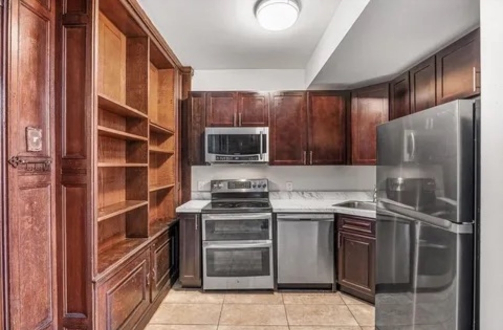 48 Washington Avenue, Unit 202 Chelsea, MA 02150 - Photo 3 of 13 a kitchen with a stove sink and refrigerator