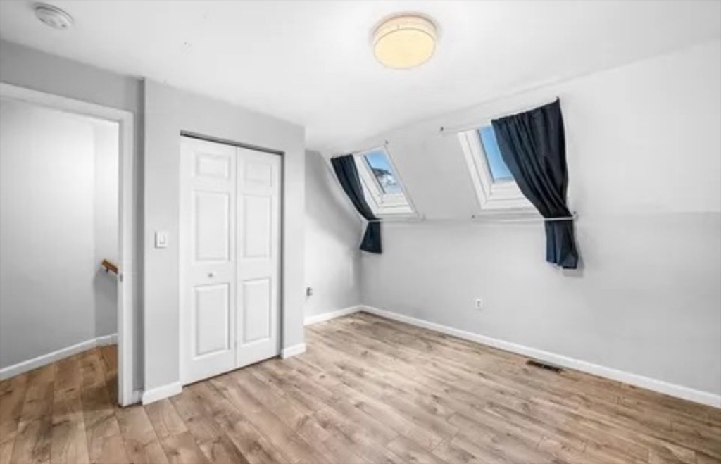 48 Washington Avenue, Unit 202 Chelsea, MA 02150 - Photo 9 of 13 a view of an empty room with wooden floor and a window