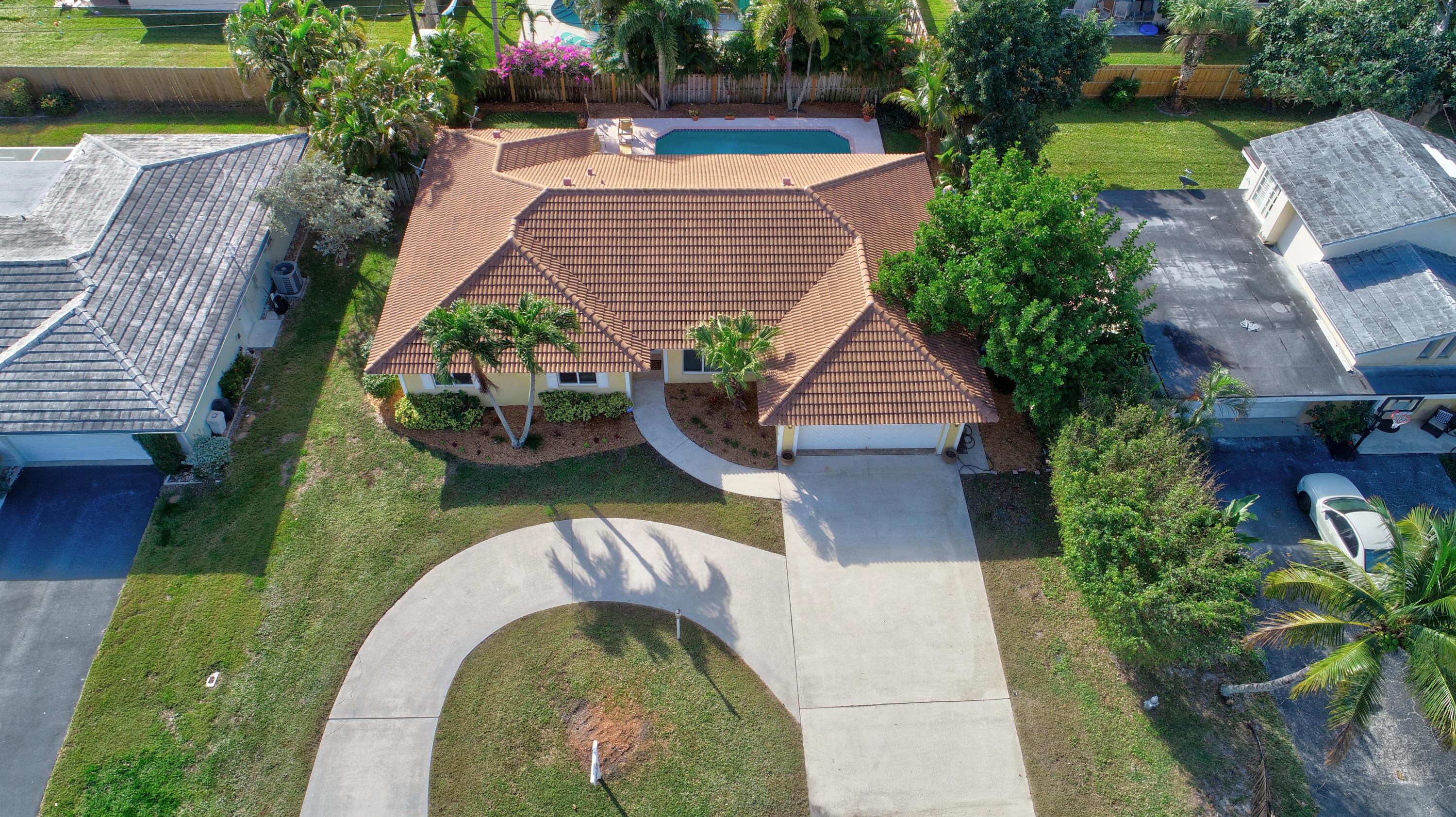 1990 Bonnie Street Boca Raton, FL 33486 - Photo 1 of 28 an aerial view of a house with garden