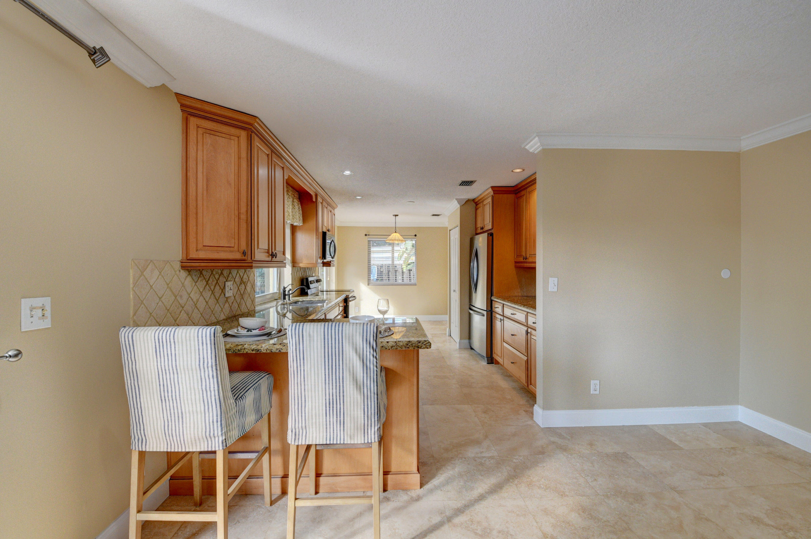 1990 Bonnie Street Boca Raton, FL 33486 - Photo 16 of 28 a view of a dining room with furniture