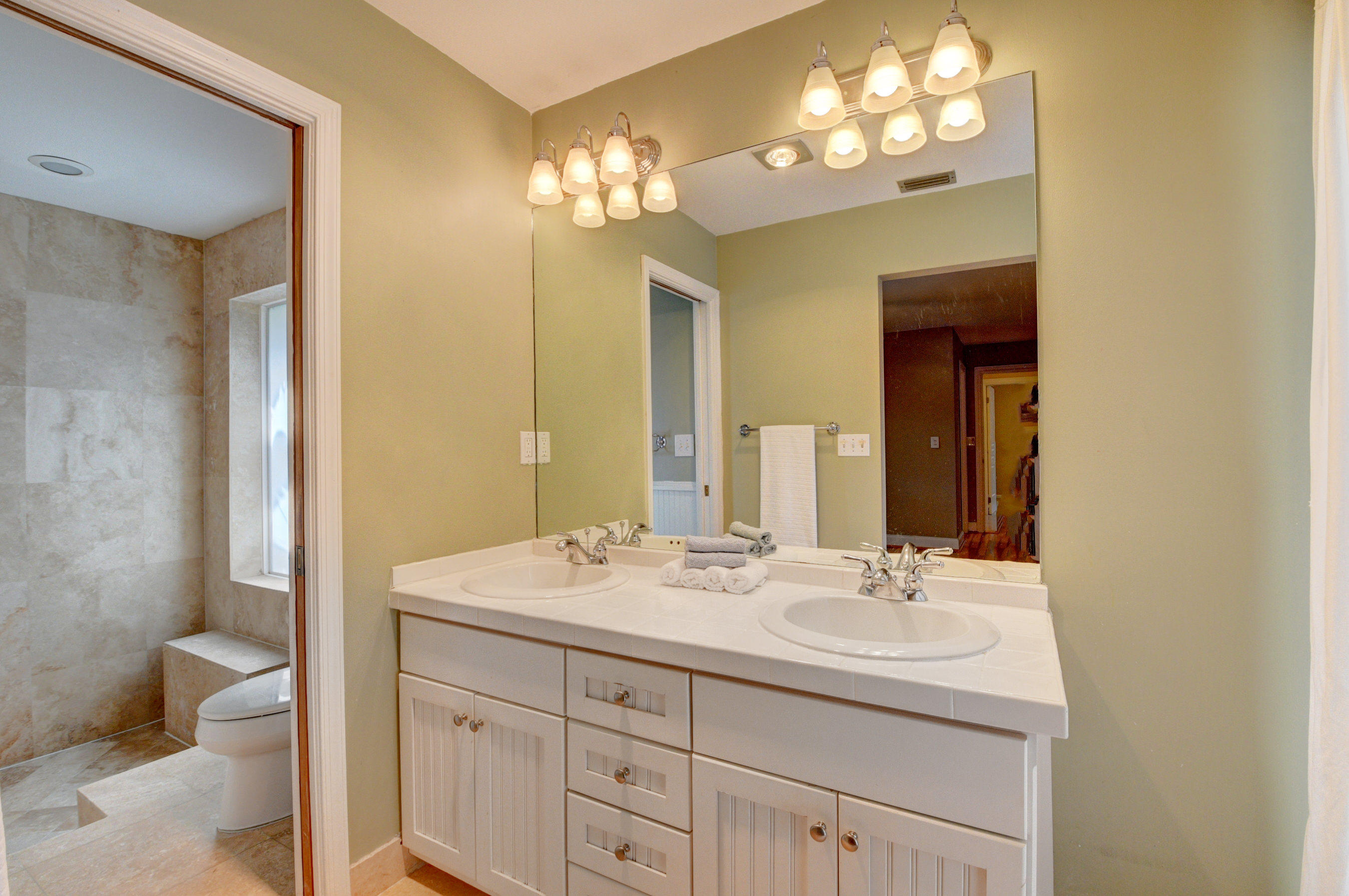1990 Bonnie Street Boca Raton, FL 33486 - Photo 18 of 28 a bathroom with a sink double vanity and a toilet