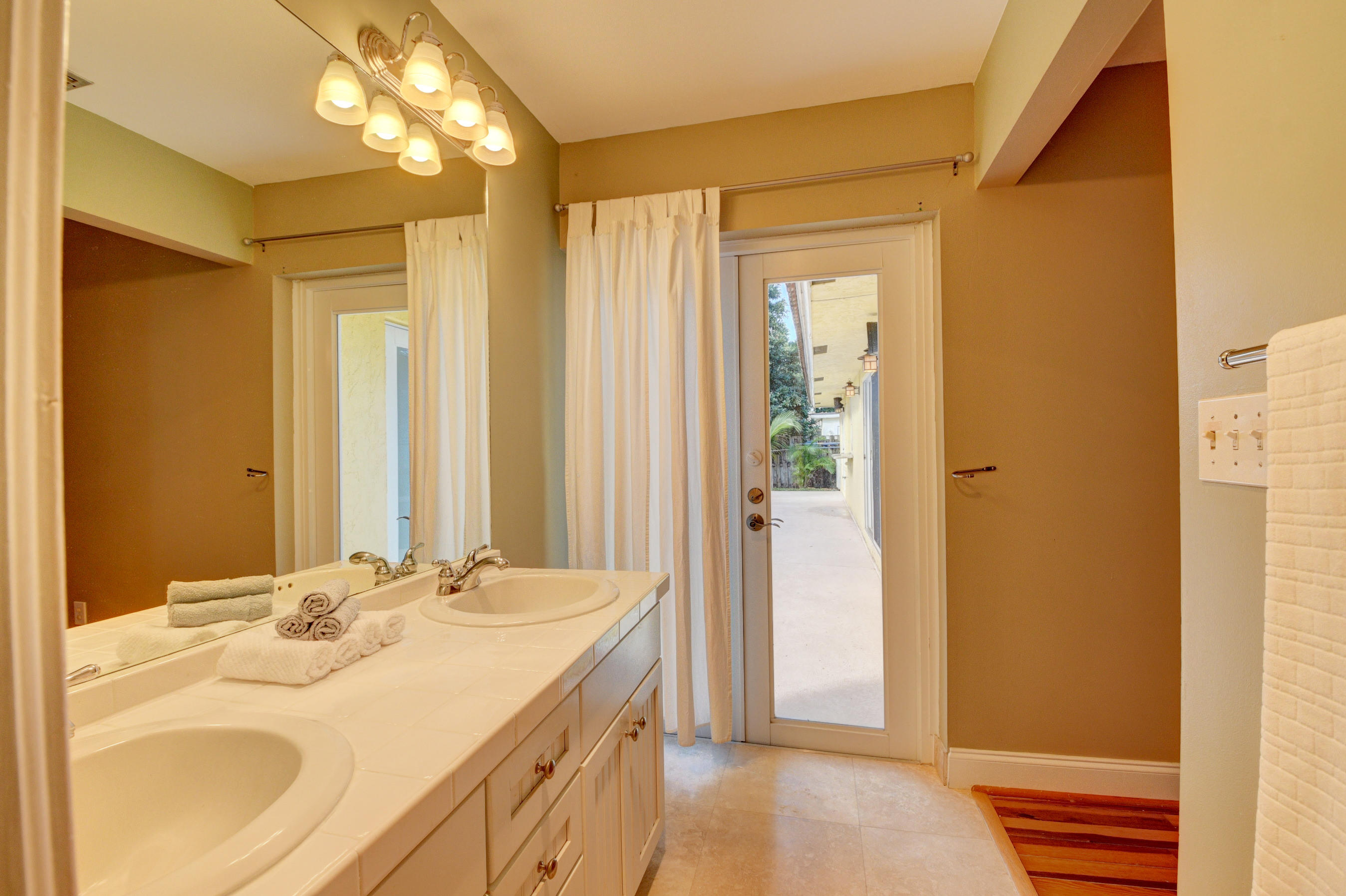 1990 Bonnie Street Boca Raton, FL 33486 - Photo 19 of 28 a bathroom with a sink and a mirror