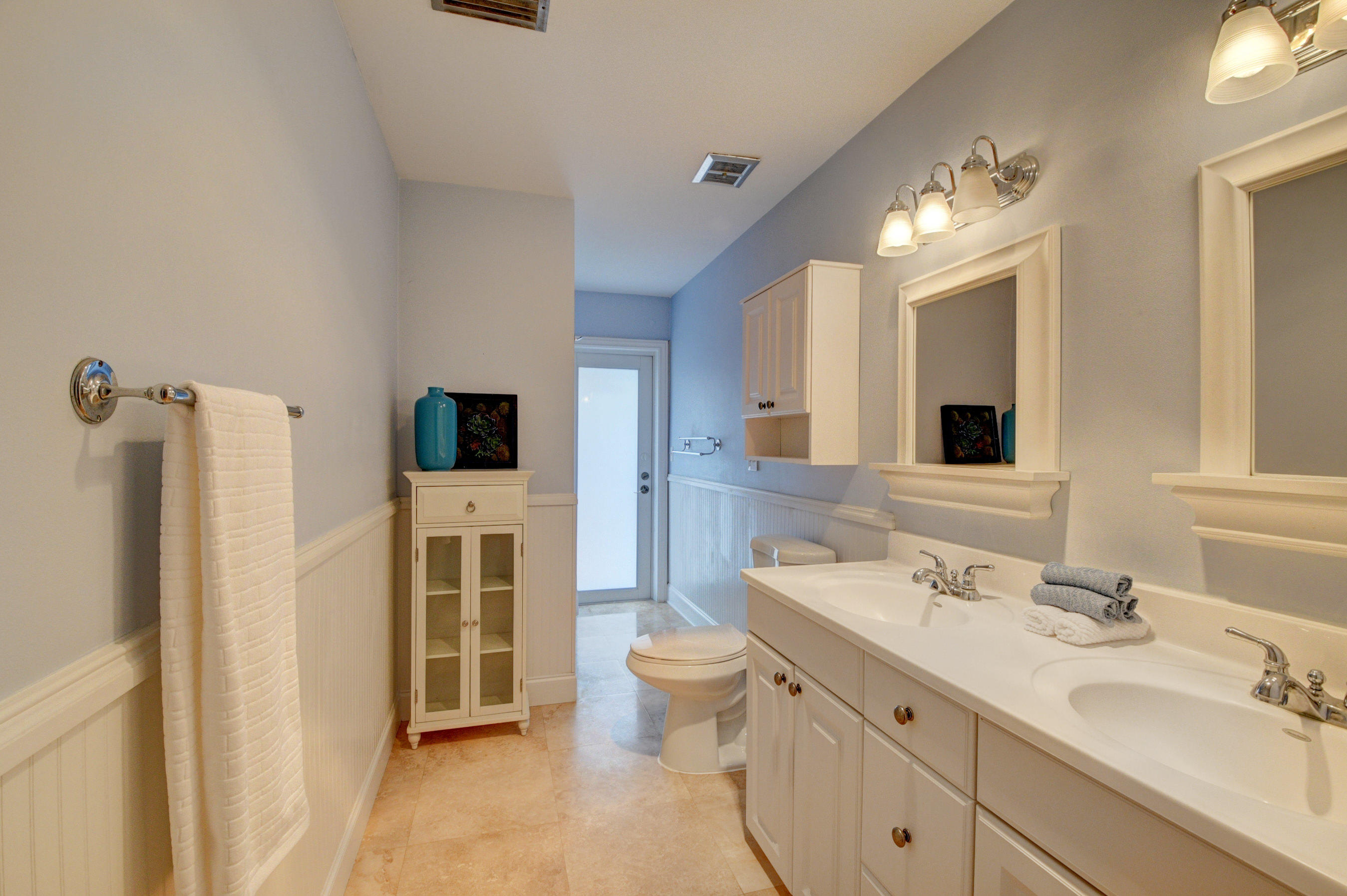 1990 Bonnie Street Boca Raton, FL 33486 - Photo 24 of 28 a spacious bathroom with a double vanity sink mirror and toilet