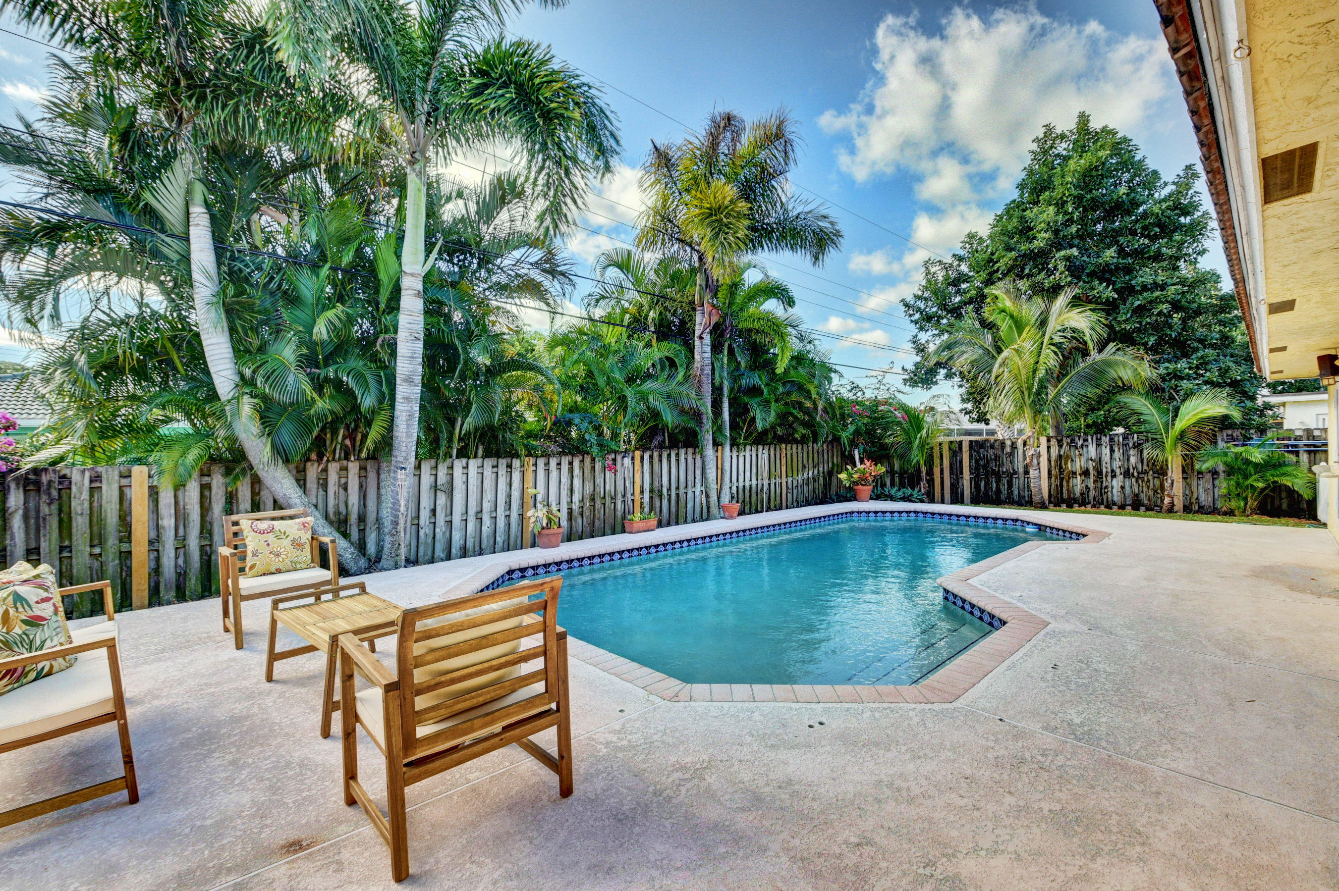 1990 Bonnie Street Boca Raton, FL 33486 - Photo 26 of 28 a view of a swimming pool with a patio and a garden