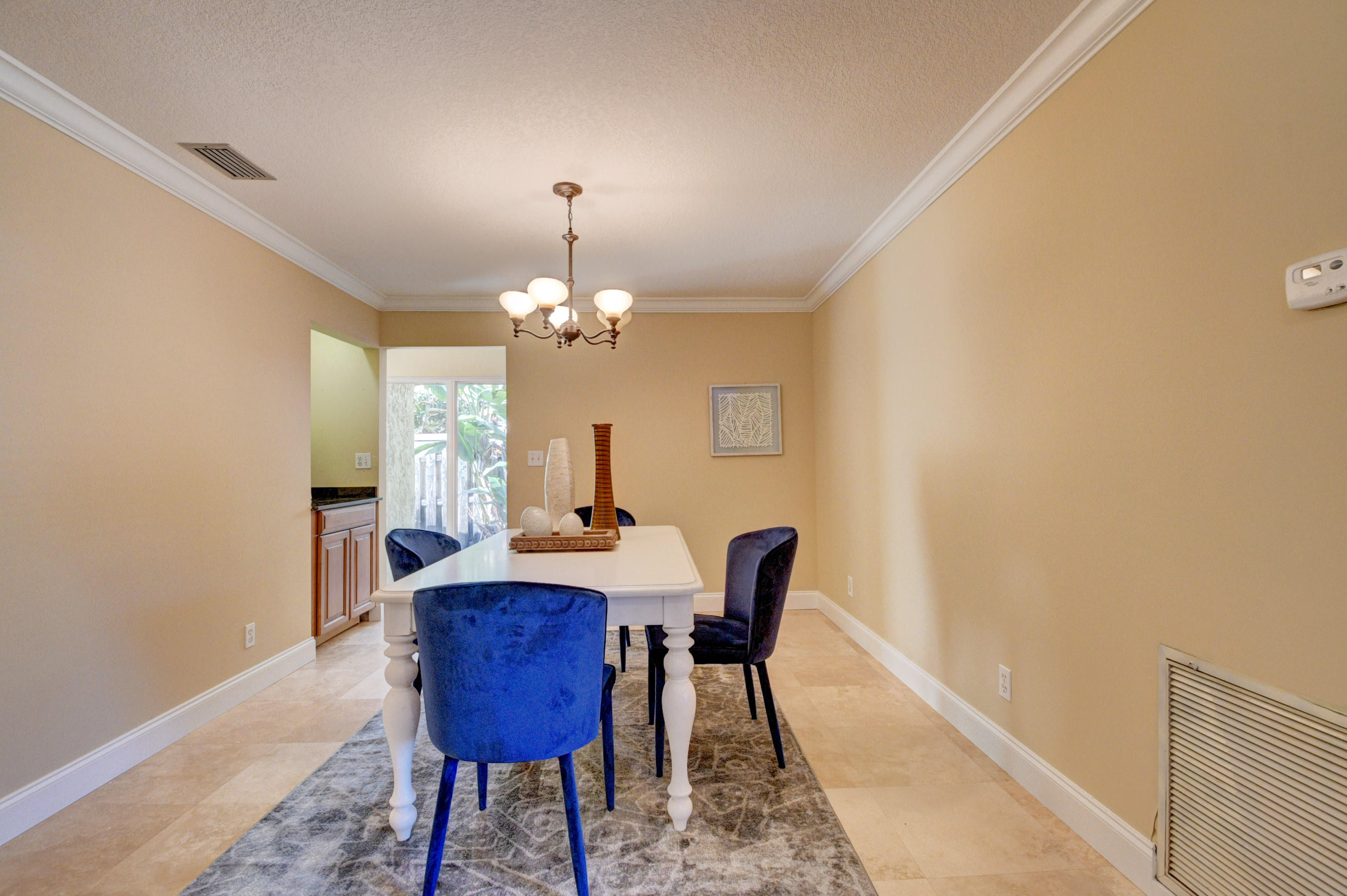 1990 Bonnie Street Boca Raton, FL 33486 - Photo 7 of 28 a view of a dining room with furniture and a chandelier