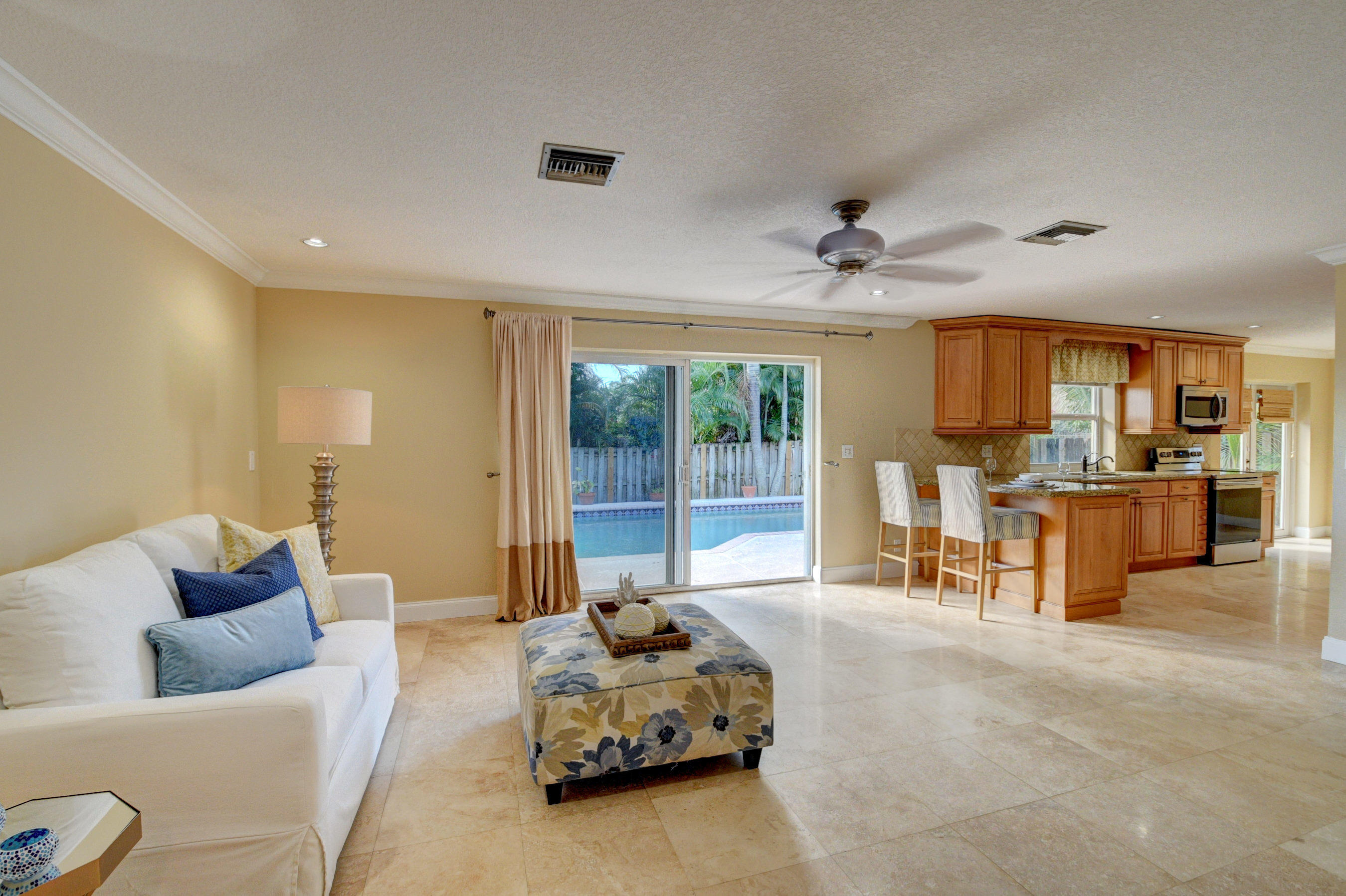 1990 Bonnie Street Boca Raton, FL 33486 - Photo 9 of 28 a living room with furniture and kitchen view