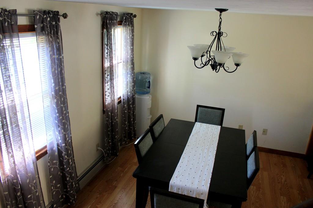 68 Valley Road Dracut, MA 01826 - Photo 10 of 25 a view of a dining room with furniture and wooden floor