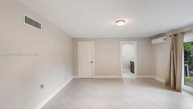 a room with wooden floor and a glass door