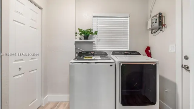 a kitchen with stainless steel appliances granite countertop a sink and a stove top oven with wooden floor