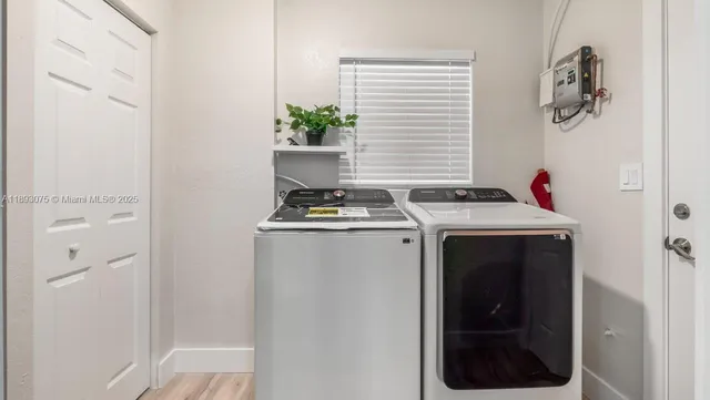 a kitchen with stainless steel appliances granite countertop a refrigerator and white cabinets
