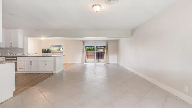 an aerial view of a house with garden space and street view
