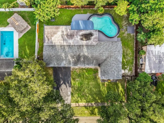 a view of a house with pool and a yard