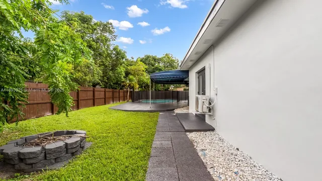 a view of a backyard with sitting area