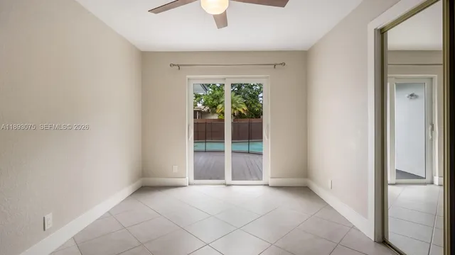 an empty room with windows and closet