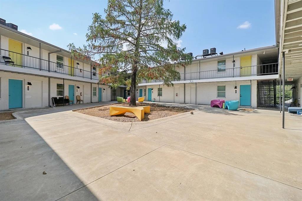 321 East 8th Street, Unit 104 Dallas, TX 75203 - Photo 3 of 15 a front view of building with cars parked
