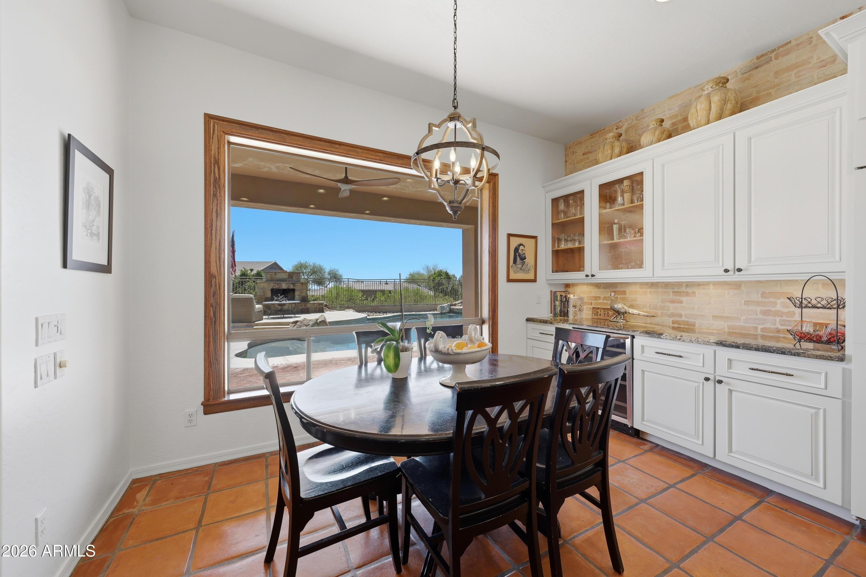 11071 East Evans Road Scottsdale, AZ 85255 - Photo 11 of 35 a dining room with furniture a chandelier and window