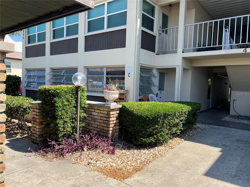 4854 Marine Parkway, Unit 103 New Port Richey, FL 34652 - Photo 2 of 21 a view of a house with a yard