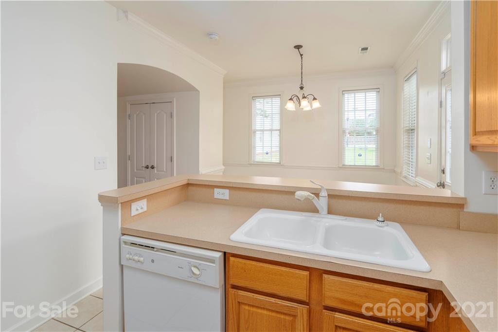 652 Old Meeting Way Davidson, NC 28036 - Photo 13 of 32 a view of a kitchen with a sink and chandelier