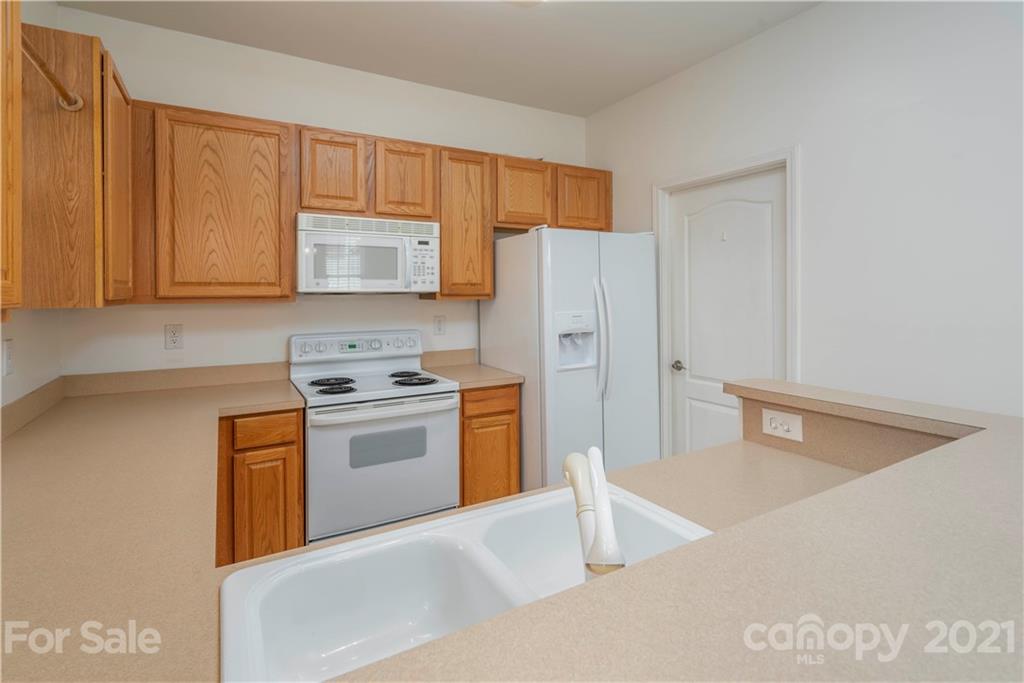652 Old Meeting Way Davidson, NC 28036 - Photo 15 of 32 a kitchen with stainless steel appliances granite countertop a refrigerator a stove and a sink