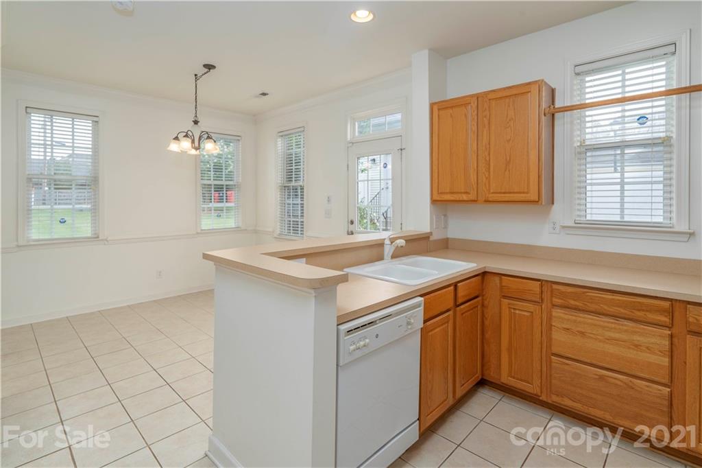 652 Old Meeting Way Davidson, NC 28036 - Photo 16 of 32 a kitchen with a sink cabinets appliances and a window