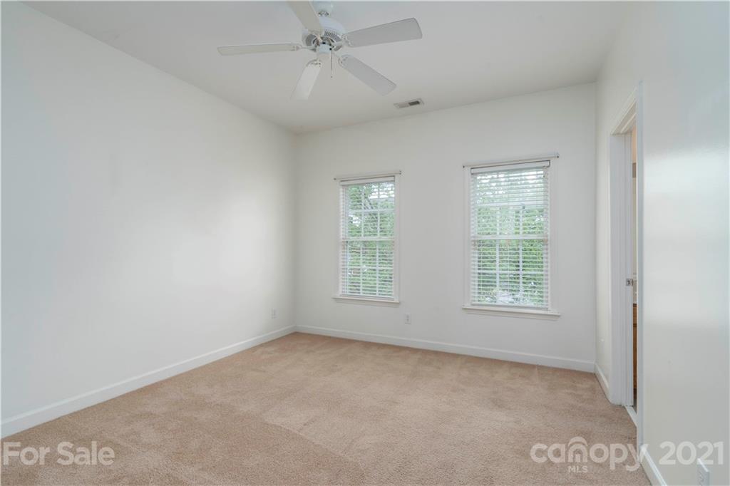 652 Old Meeting Way Davidson, NC 28036 - Photo 18 of 32 an empty room with a window and a fan