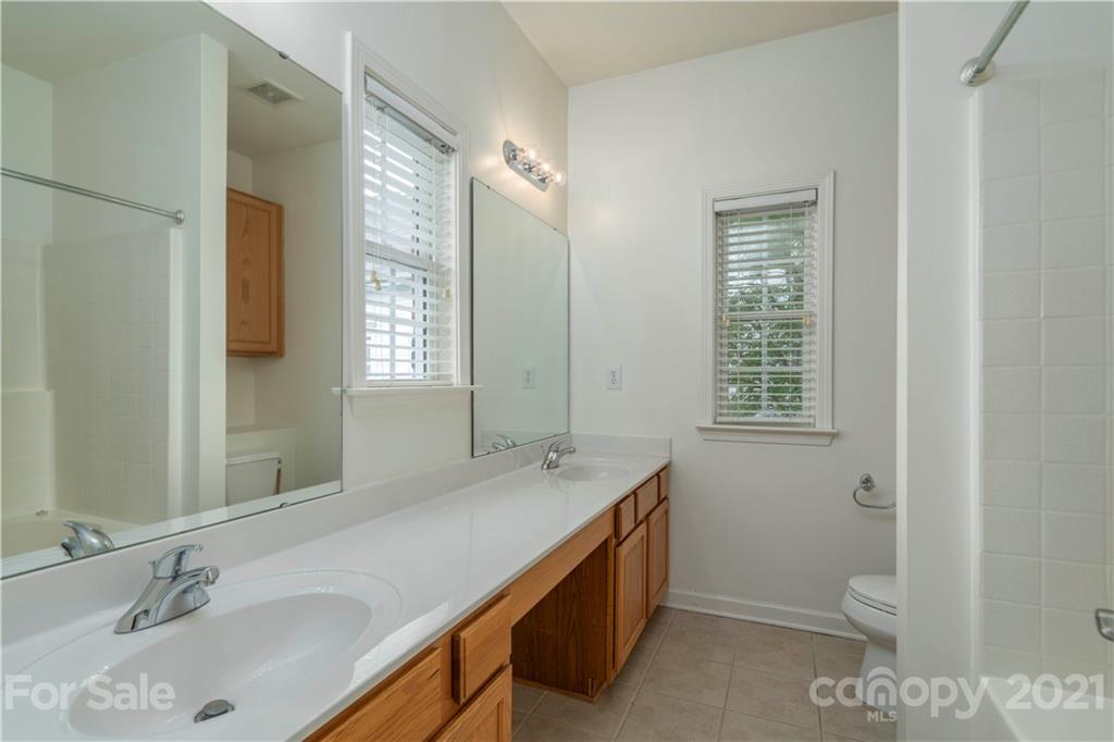652 Old Meeting Way Davidson, NC 28036 - Photo 20 of 32 a bathroom with a sink a toilet and shower