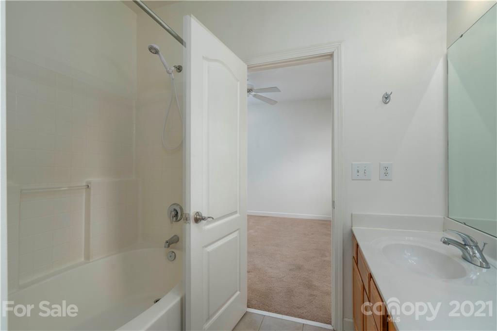 652 Old Meeting Way Davidson, NC 28036 - Photo 21 of 32 a bathroom with a tub shower sink and vanity