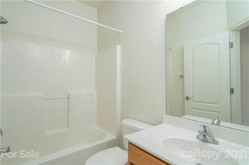 652 Old Meeting Way Davidson, NC 28036 - Photo 25 of 32 a bathroom with a granite countertop sink toilet and shower