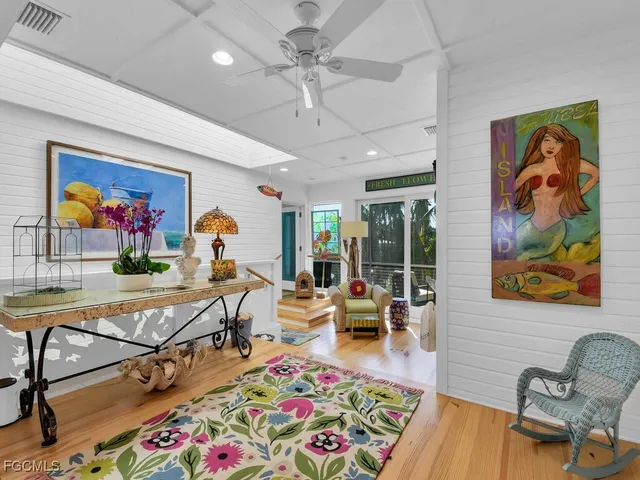 a room with lots of furniture and view of kitchen