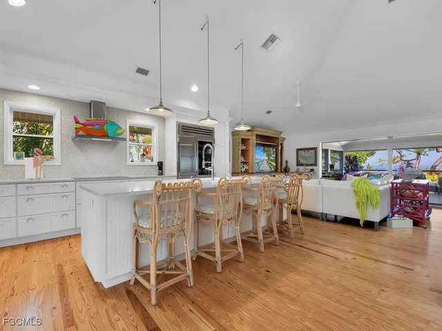 a kitchen with stainless steel appliances granite countertop a stove and cabinets