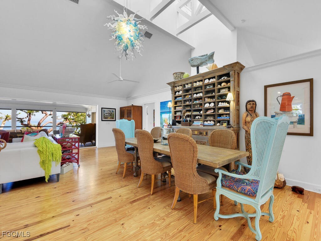 8315 Main Street Bokeelia, FL 33922 - Photo 20 of 50 a view of a dining room with furniture and wooden floor