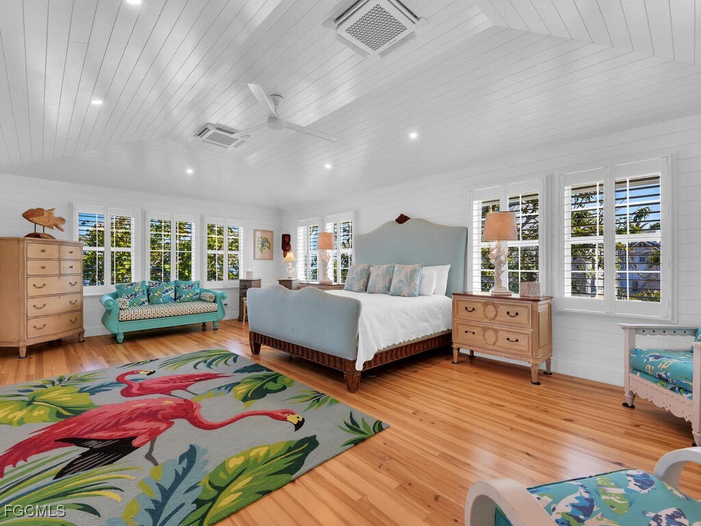 8315 Main Street Bokeelia, FL 33922 - Photo 25 of 50 a bedroom with a bed and wooden floor
