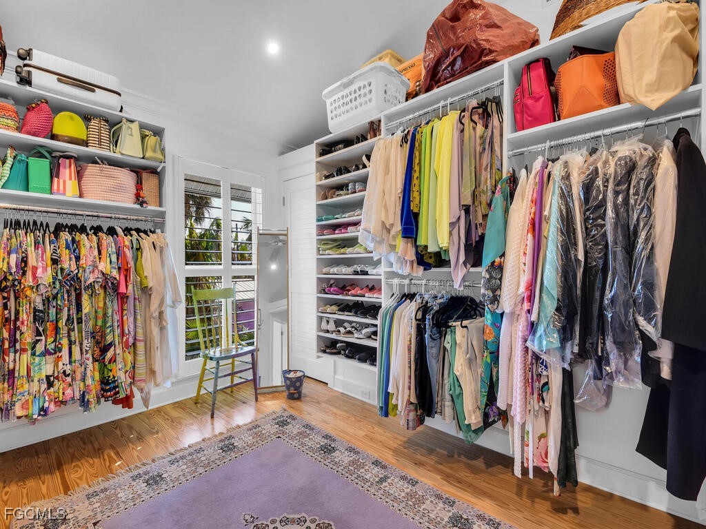 8315 Main Street Bokeelia, FL 33922 - Photo 29 of 50 a view of walk in closet with clothes and shoes