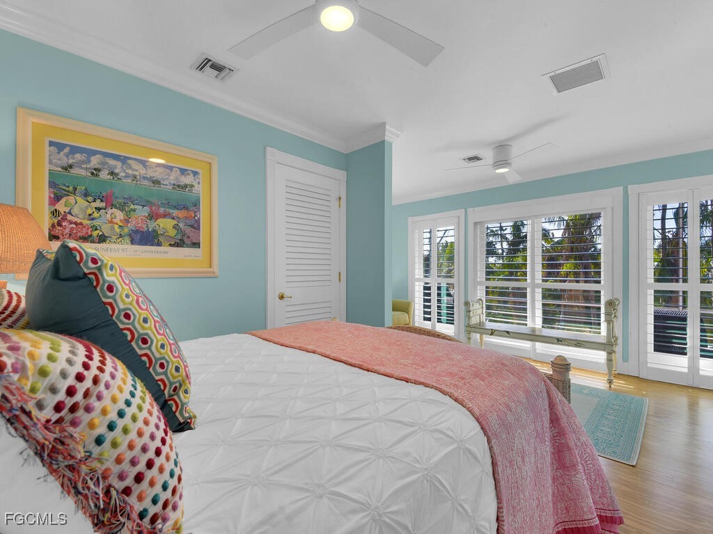 8315 Main Street Bokeelia, FL 33922 - Photo 30 of 50 a bedroom with a large bed and a large window