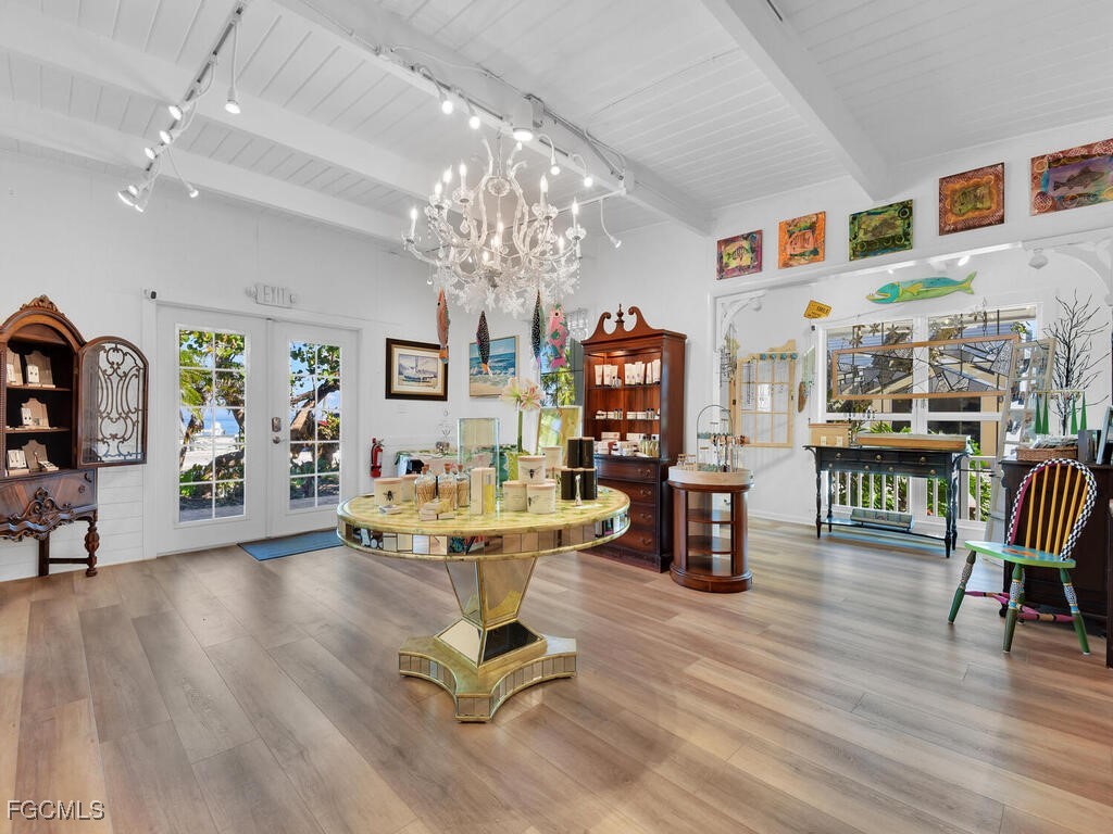 8315 Main Street Bokeelia, FL 33922 - Photo 39 of 50 a living room with furniture and a chandelier