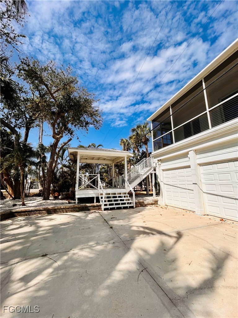 8315 Main Street Bokeelia, FL 33922 - Photo 7 of 50 a view of a building with a snow in the yard