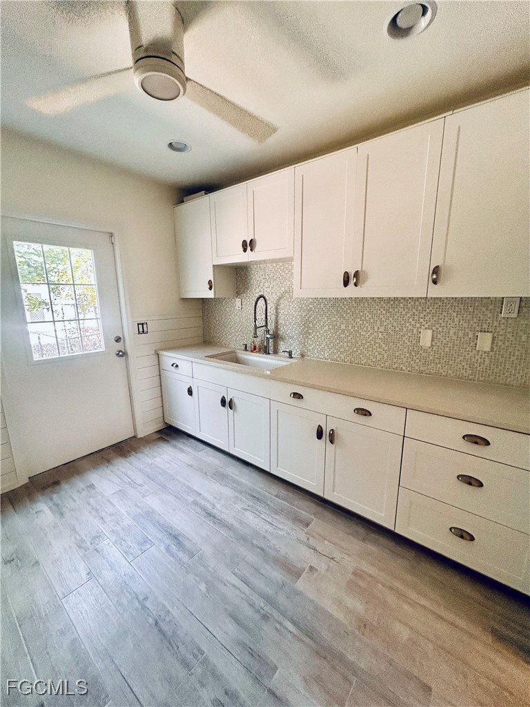 8315 Main Street Bokeelia, FL 33922 - Photo 8 of 50 a kitchen with granite countertop white cabinets and white appliances
