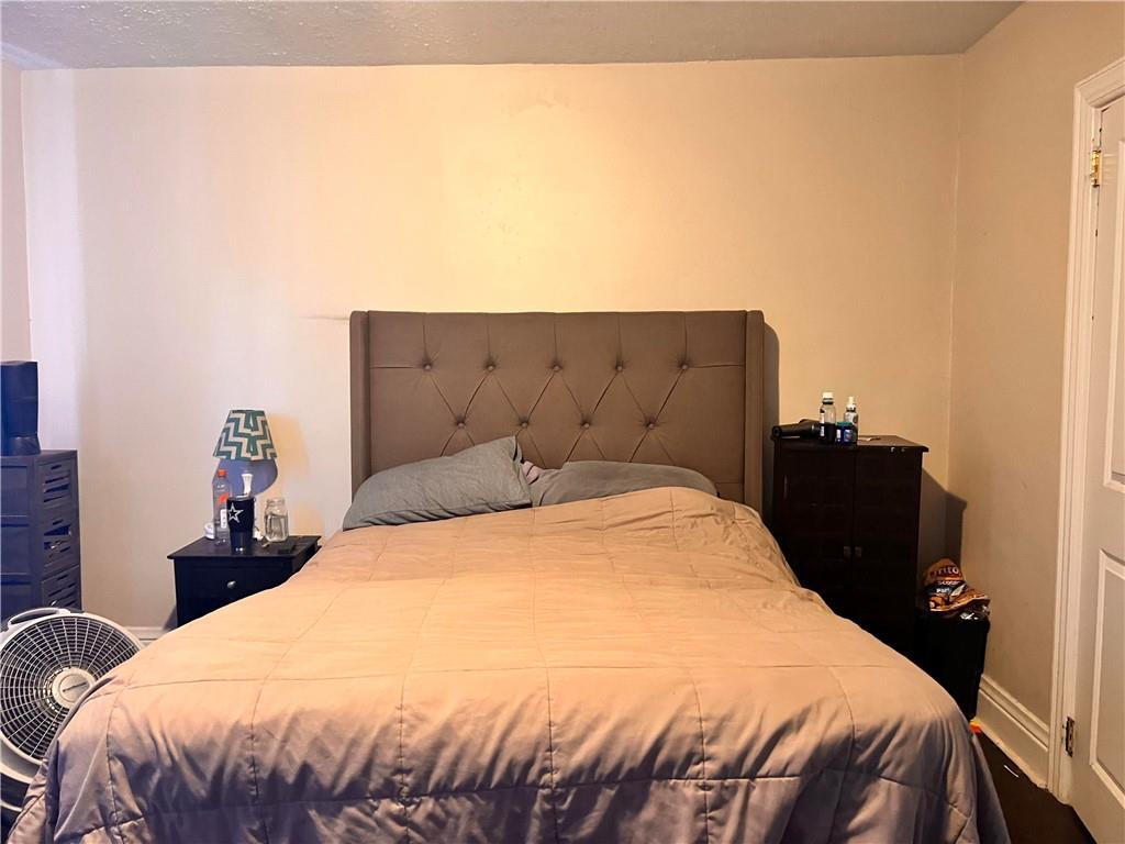 405 Grove Street McKees Rocks, PA 15136 - Photo 6 of 7 a bedroom with a bed and a night stand